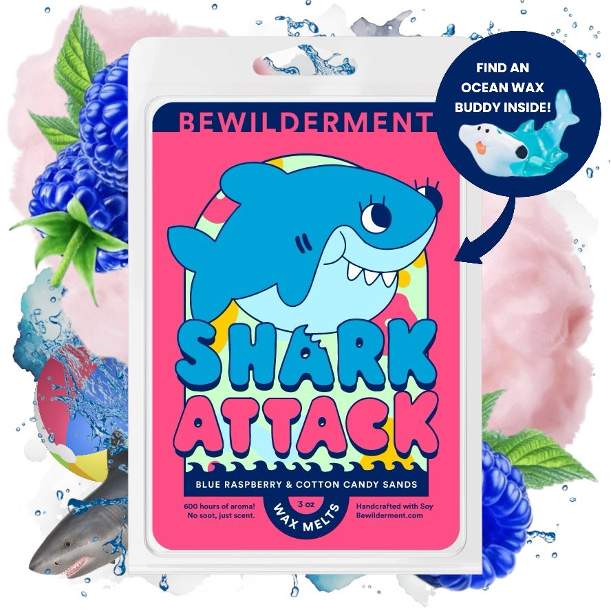 Blue shark cartoon on pink label for Shark Attack wax melts with berry and cotton candy scent.